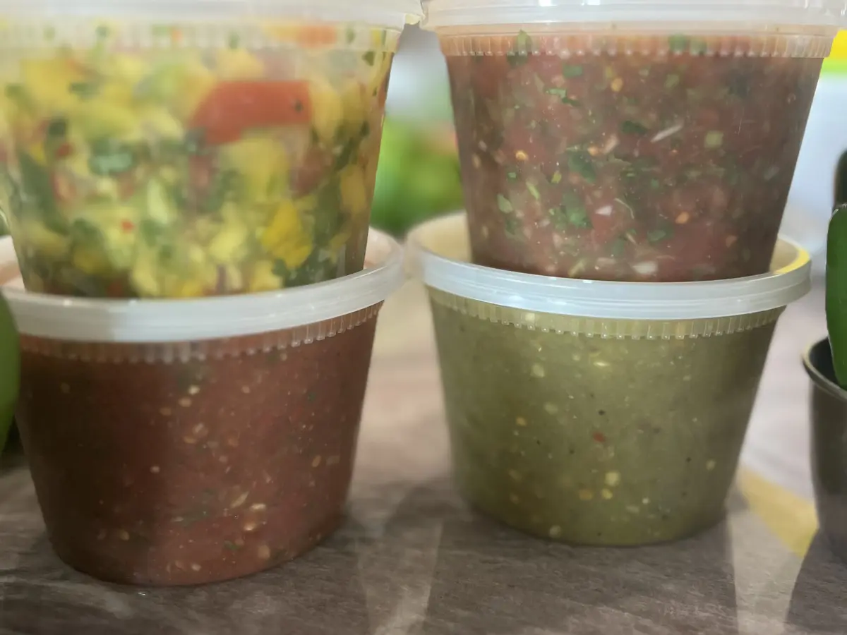 Close-up of Colita’s mango, red, and green homemade salsas